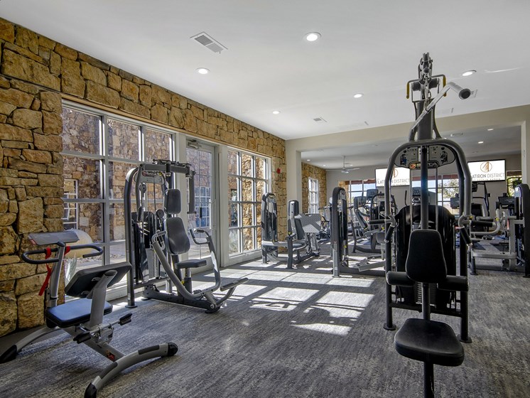 The Colony TX Apartments-Flatiron District at Austin Ranch Gym with Flat-Screen TV's, Lots of Weight Machines, and Cardio Machines